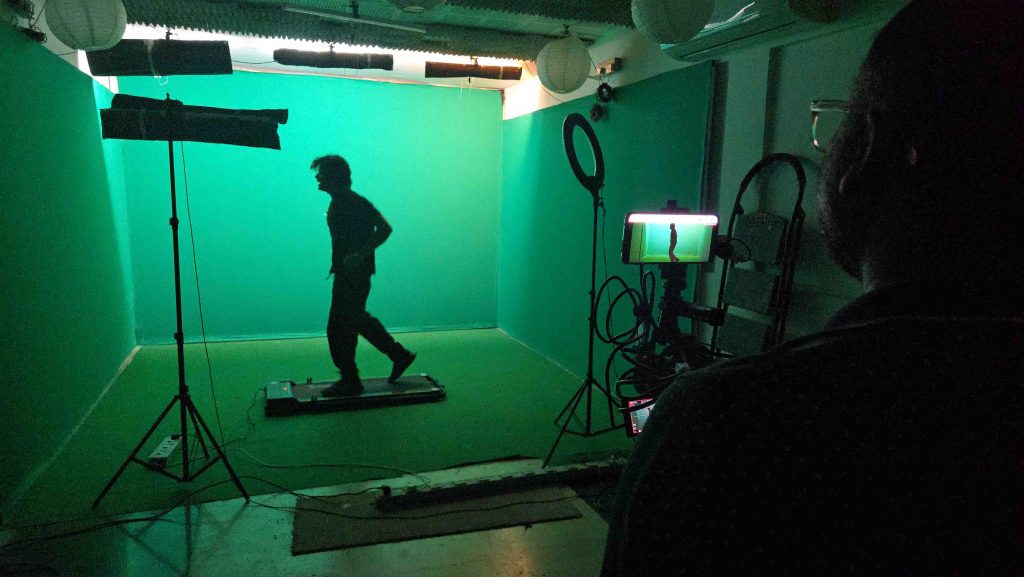 green screen chroma studio with furniture & lights & treadmill for walking shots.